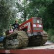 Buurjongen op rupsbanden-tractor